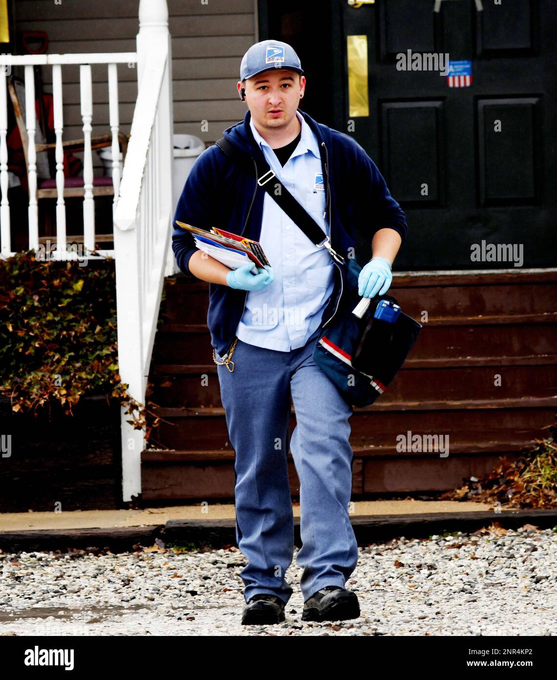 A postal worker delivers mail along Route 20 across from Assumption Church in Geneva, Ohio, on
