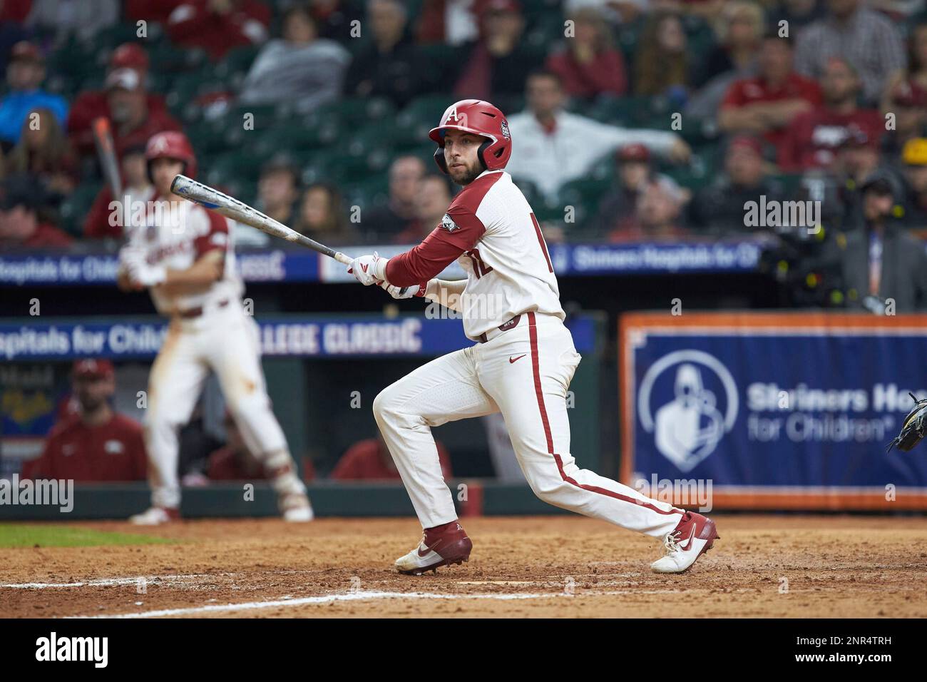 Casey Opitz (12) of the Arkansas Razorbacks follows through on his ...