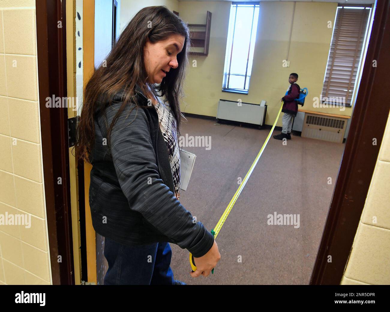 Kimberly Kretzmer and Elijah, 10, take measurements in former