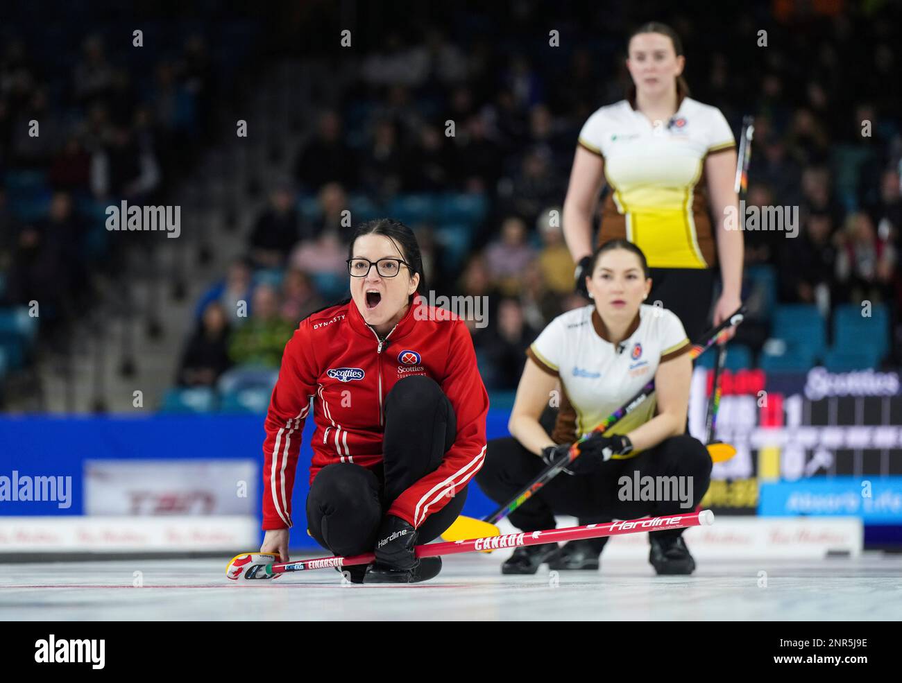 Team Canada skip Kerri Einarson, front left, calls to the sweepers as Manitoba third Karlee Burgess, back lower right, and lead Lauren Lenentine watch the shot during the final at the Scotties