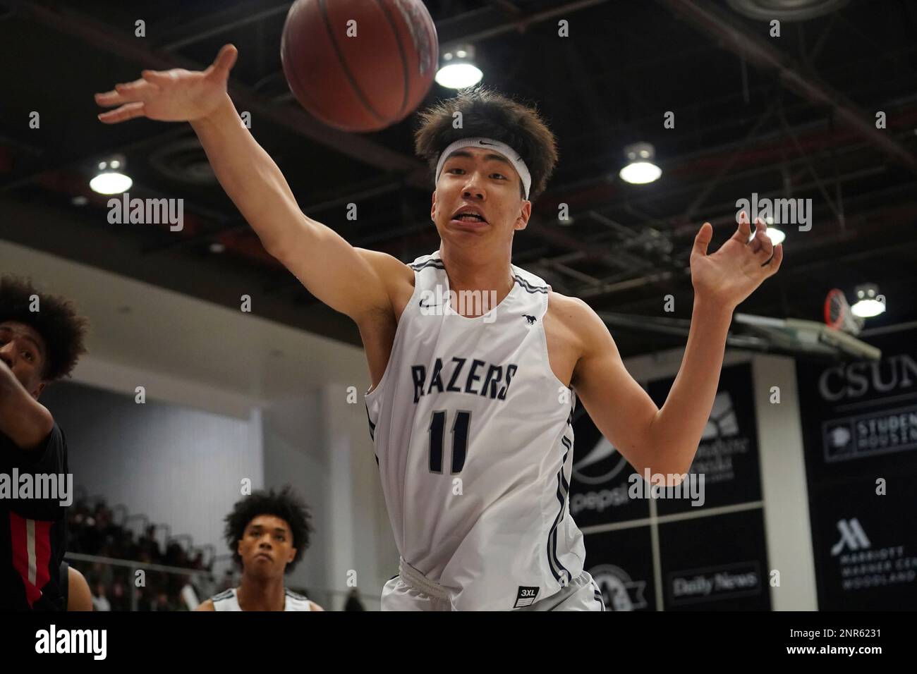 Sierra Canyon Trailblazers center Harold Yu (11) reaches for the ball  against the Etiwanda Eagles during a CIF State Open Division Southern  Regional final high school basketball game, Tuesday, March 10, 2020,