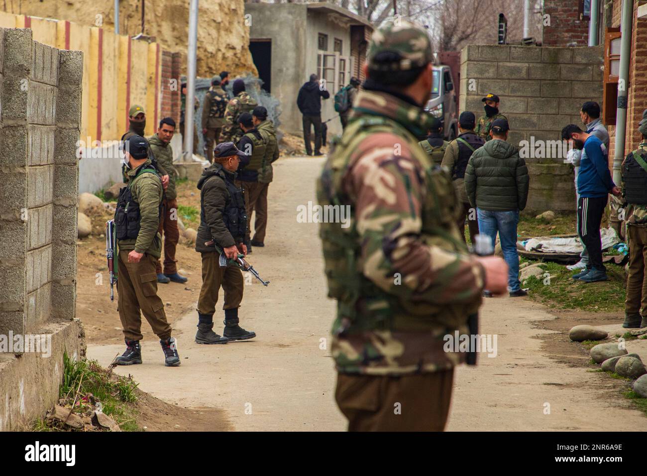 Srinagar, India. 25th Feb, 2023. Indian paramilitary troopers stand on guard at the attack site where Sanjay Sharma a Kashmiri Hindu bank security guard was shot dead by suspected militants in Pulwama South of Indian administered Kashmir. Police said suspected militants opened fire on Sanjay Sharma while he was on his way to a local market in Achan village Pulwama district. Credit: SOPA Images Limited/Alamy Live News Stock Photo