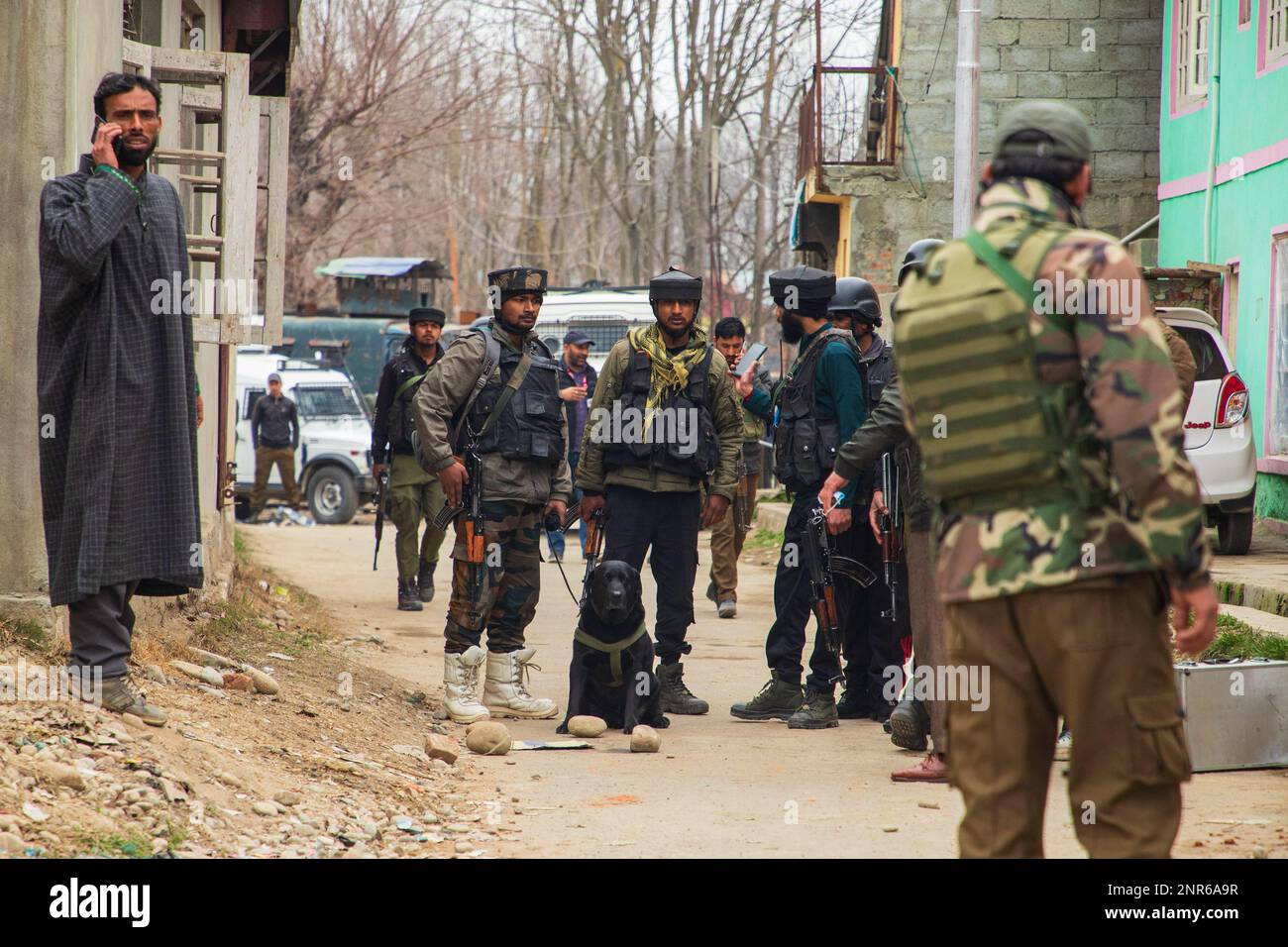Srinagar, India. 25th Feb, 2023. Indian paramilitary troopers stand on guard at the attack site where Sanjay Sharma a Kashmiri Hindu bank security guard was shot dead by suspected militants in Pulwama South of Indian administered Kashmir. Police said suspected militants opened fire on Sanjay Sharma while he was on his way to a local market in Achan village Pulwama district. Credit: SOPA Images Limited/Alamy Live News Stock Photo