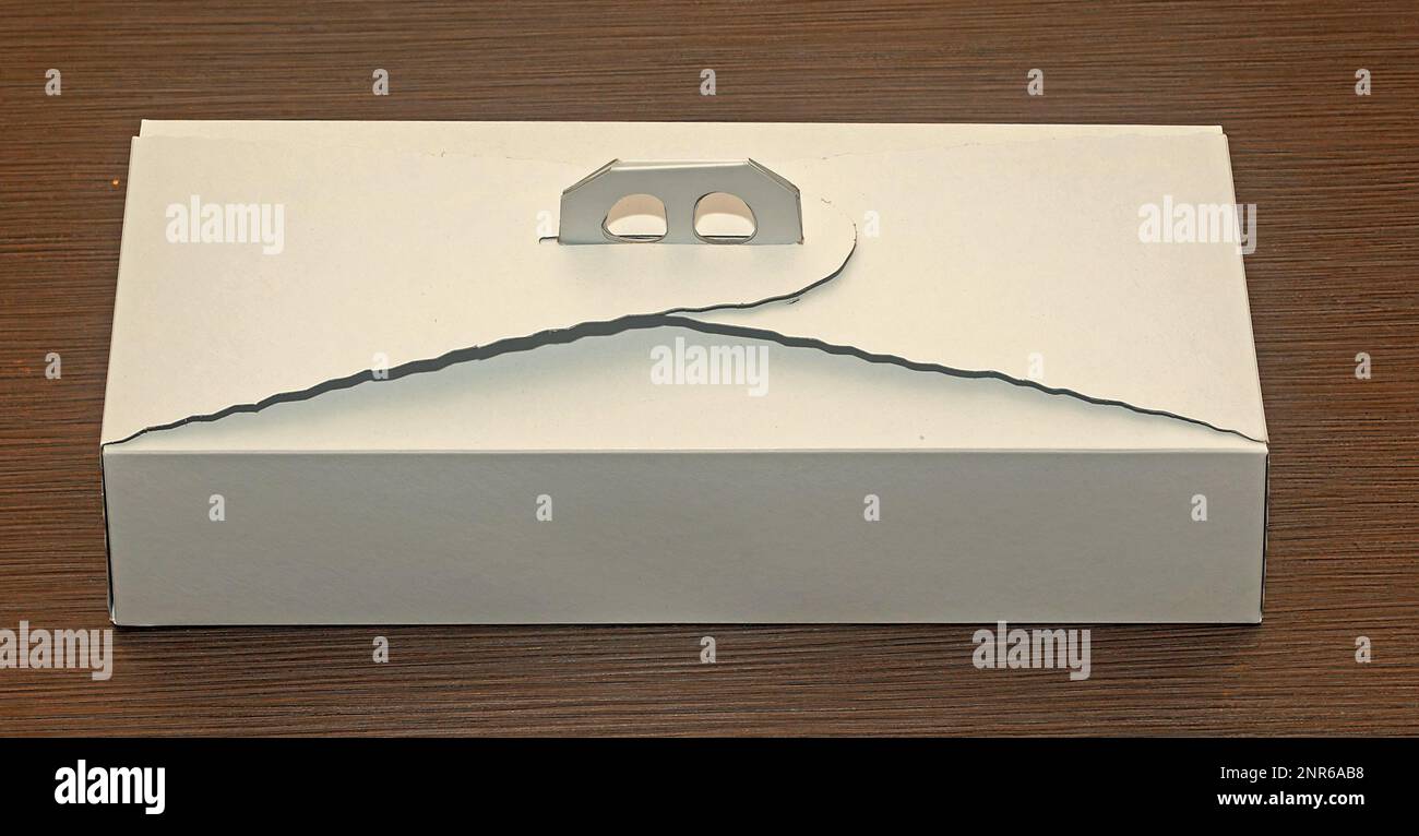 Closed cardboard white cake box on wooden table Stock Photo