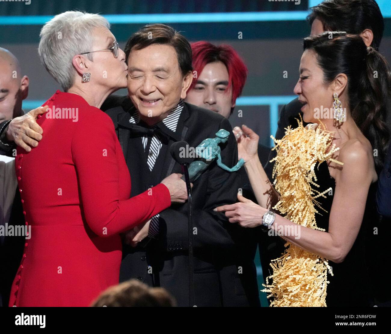 Jamie Lee Curtis, from left, James Hong, and Michelle Yeoh accept the