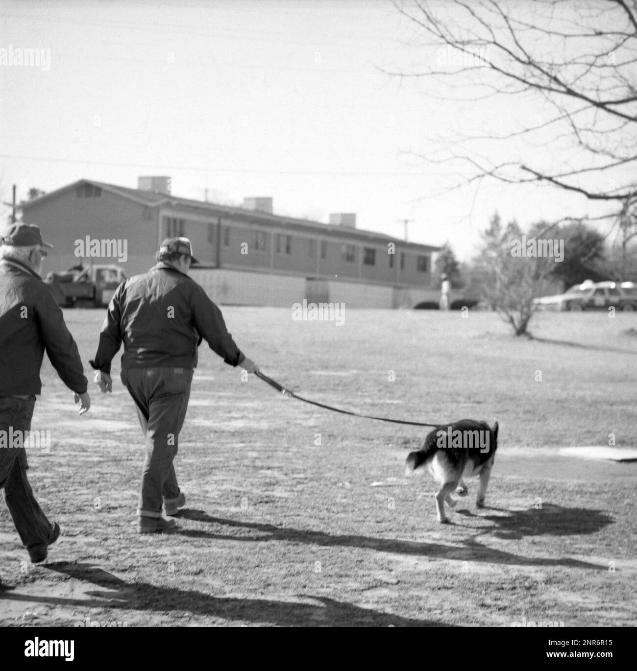 Investigators walk outside Catherine Leach's Atlanta home during the