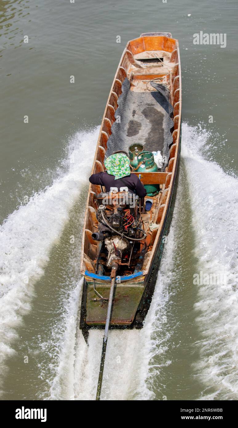 A traditional transport in Thailand - the boat with long rod of engine, sailing on a water canal. Stock Photo