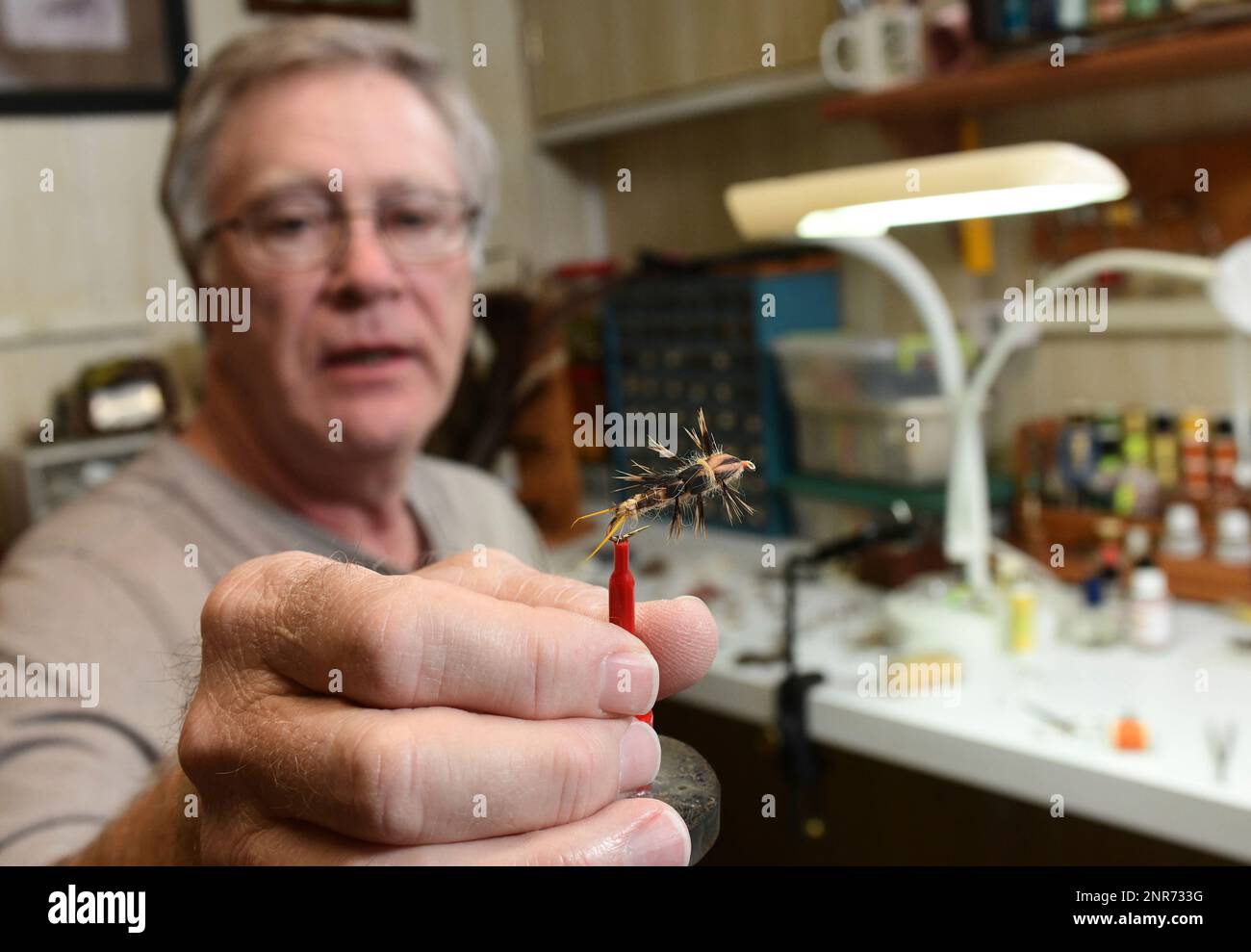 Randy Buchanan shows off a Stone Fly that he created in his home in