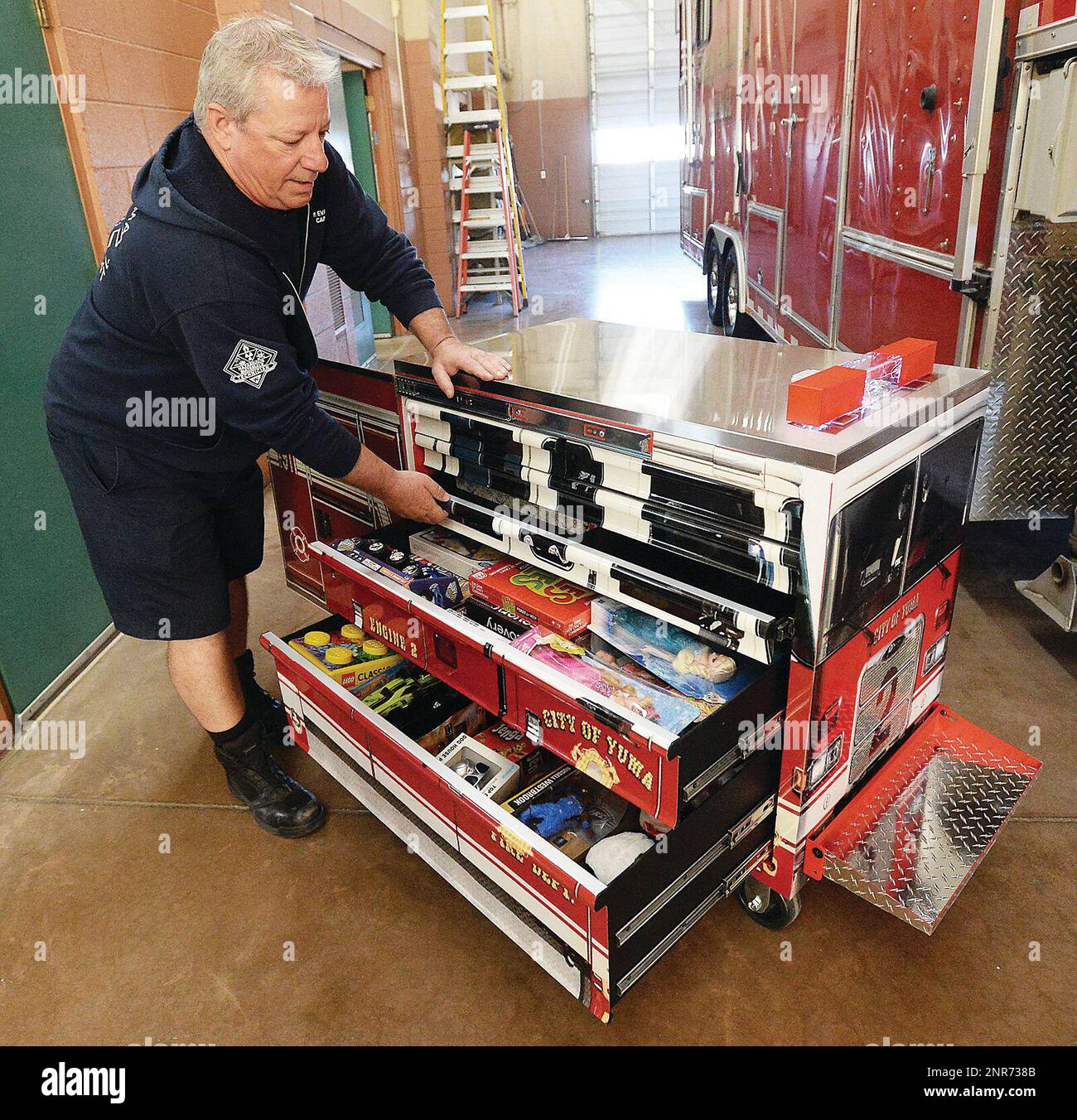 Yuma Fire Department Capt. Paul Evancho shows how his two YFD Engine No. 2 toy box replicas are