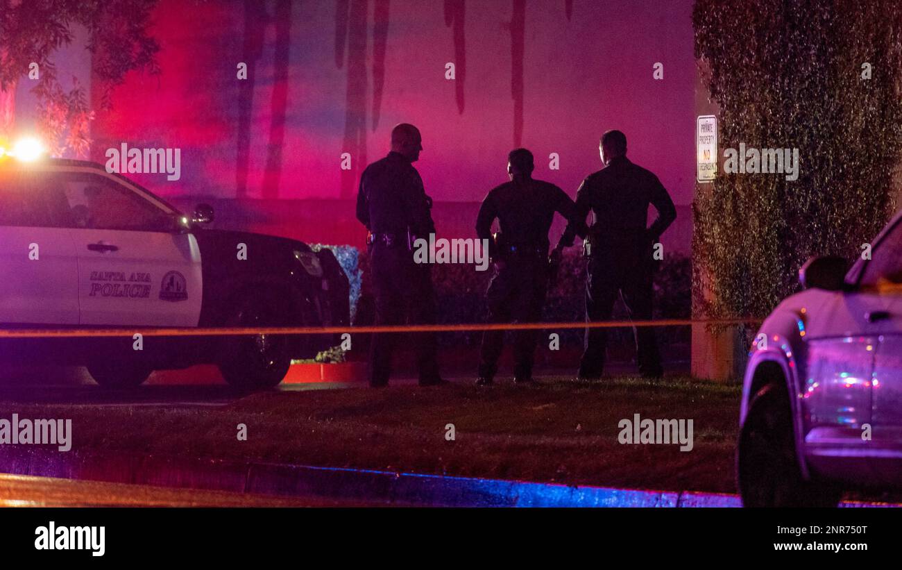 Santa Ana Police detectives stand by the scene where an armed man was ...