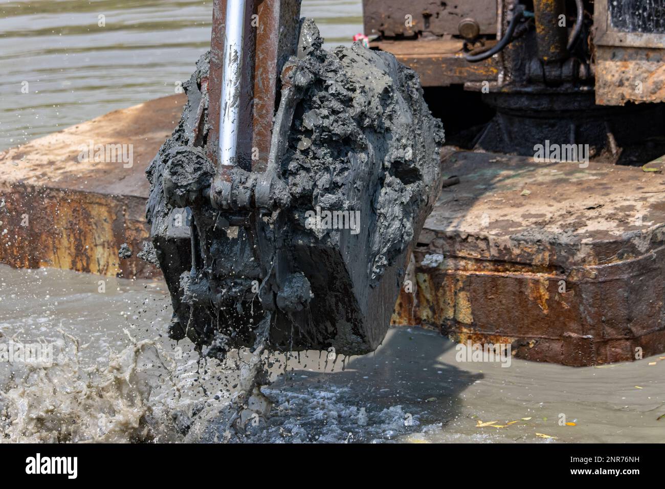 Dredging the bottom of water area, view of the bucket of the floating