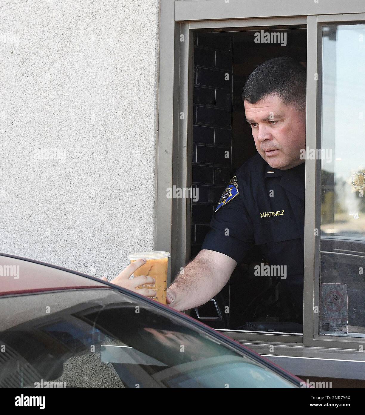 California Highway Patrol Lt. Fernando Martinez hands a beverage to a