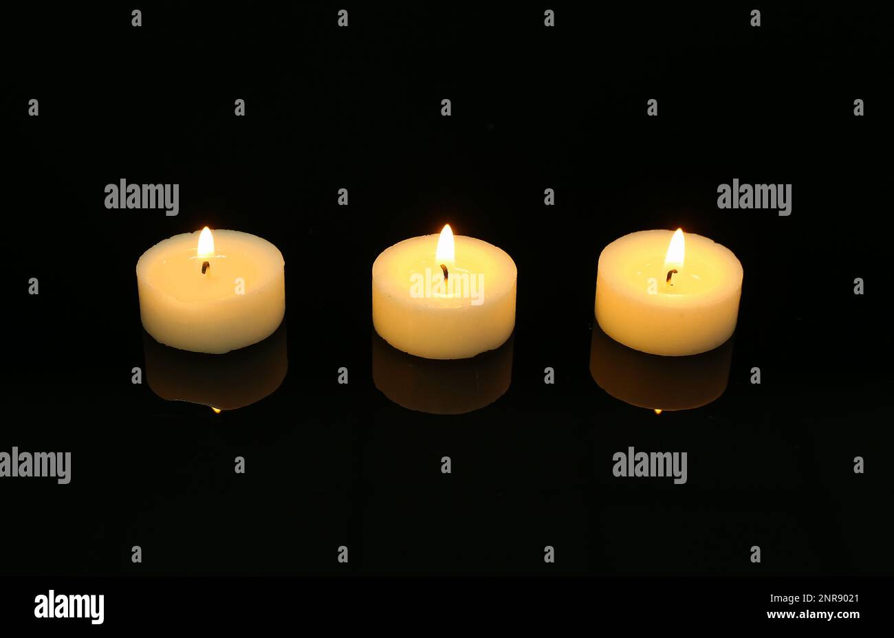 Burning candles on black background. Mourning concept Stock Photo - Alamy