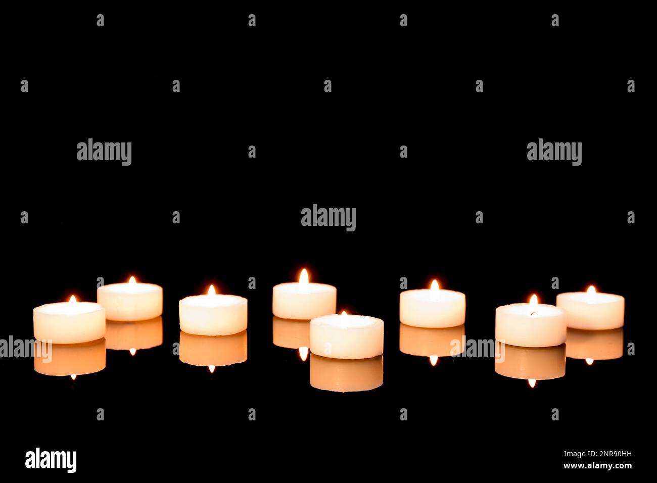 Burning candles on dark background. Mourning concept Stock Photo - Alamy