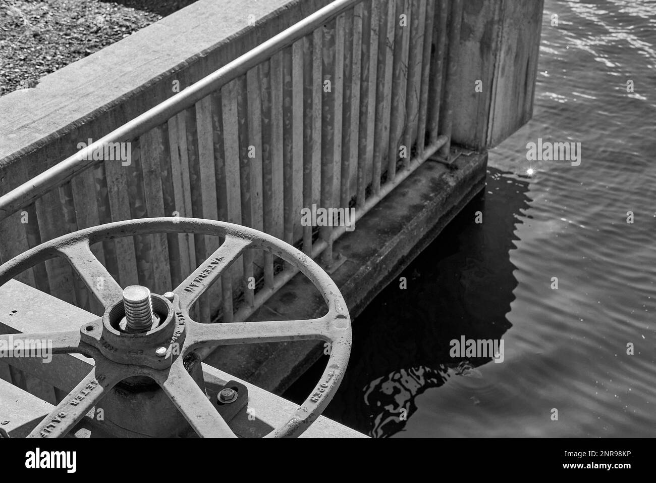 A valve controls a mill pond floodgate. Stock Photo