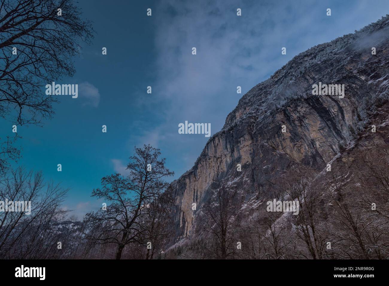View from the Lauterbrunnen valley towards epic stone rock walls rising ...