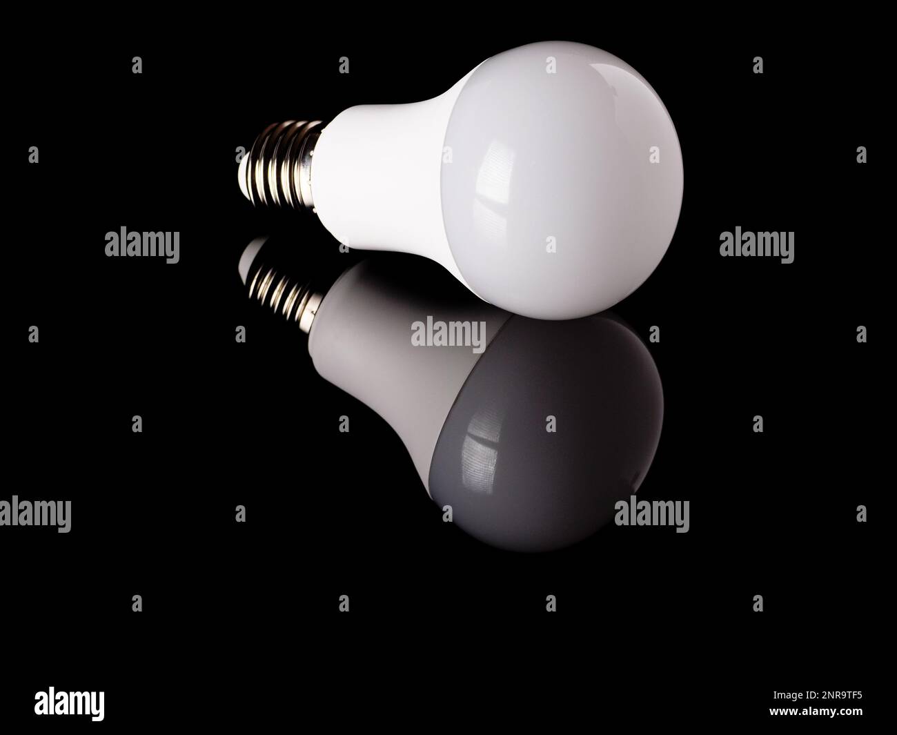 LED light bulb with reflection isolated on a black background Stock Photo