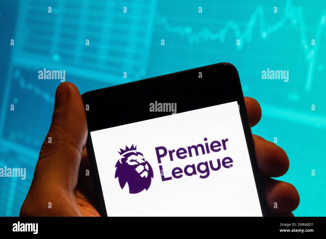China. 15th Feb, 2023. In this photo illustration, the English professional football top division league Premier League logo is seen displayed on a smartphone with an economic stock exchange index graph in the background. Credit: SOPA Images Limited/Alamy Live News Stock Photo