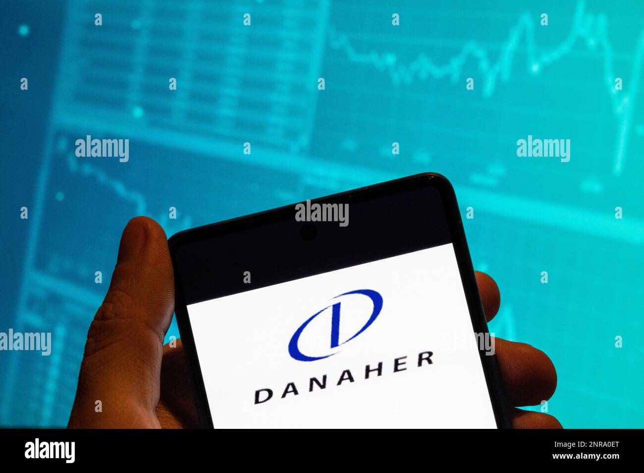 China. 15th Feb, 2023. In this photo illustration, the American conglomerate manufacturing medical, industrial, and commercial products and services, Danaher, logo is seen displayed on a smartphone with an economic stock exchange index graph in the background. Credit: SOPA Images Limited/Alamy Live News Stock Photo