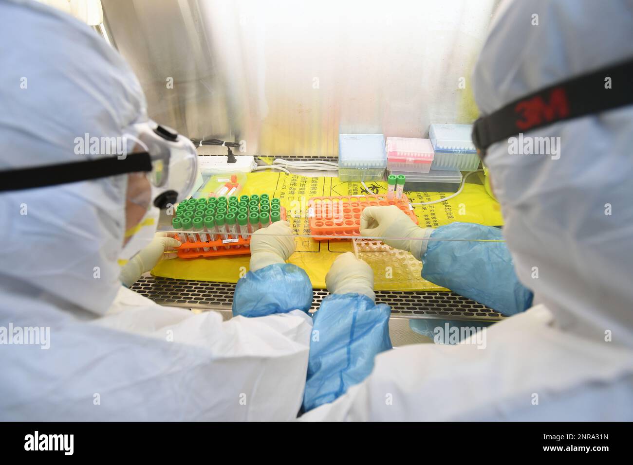 Two staff work in the pop-up Huoyan Laboratory specialized in the nucleic  acid test on 2019-nCoV in Wuhan in central China's Hubei province Thursday,  Feb. 06, 2020, the first day of its