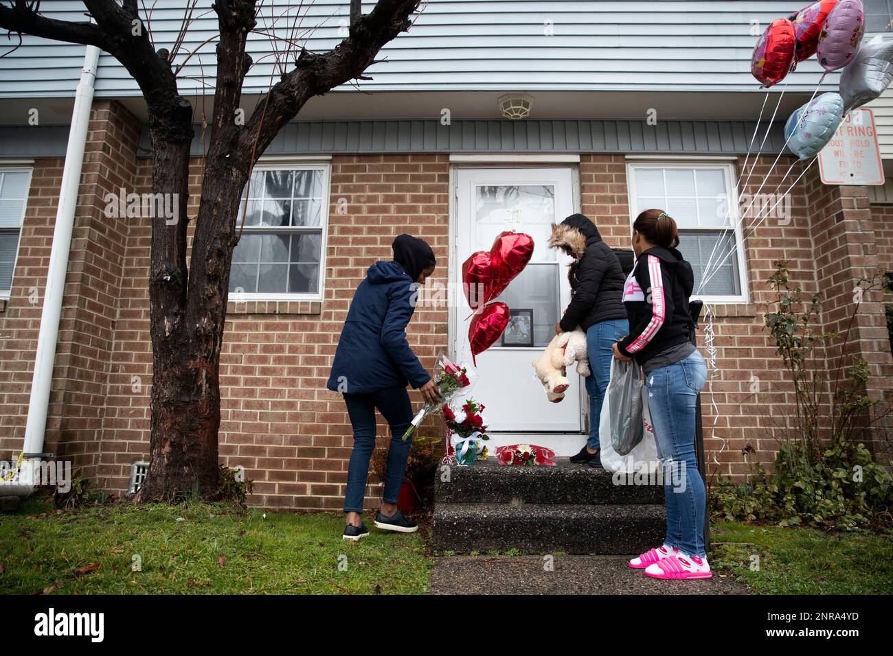 Jhoanna Ventura, Yohanny Solano and Aracelys Lebrón leave balloons, flowers  and teddy bears at the Reyes home in Penns Grove, New Jersey, on Thursday,  February 6, 2020. Ruth Reyes and her two