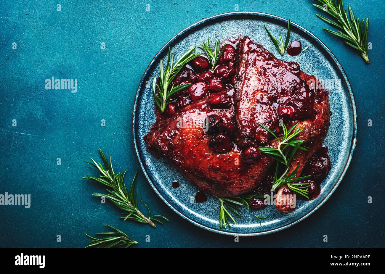 Baked duck legs in cherry and red wine sauce with rosemary. Delicacy