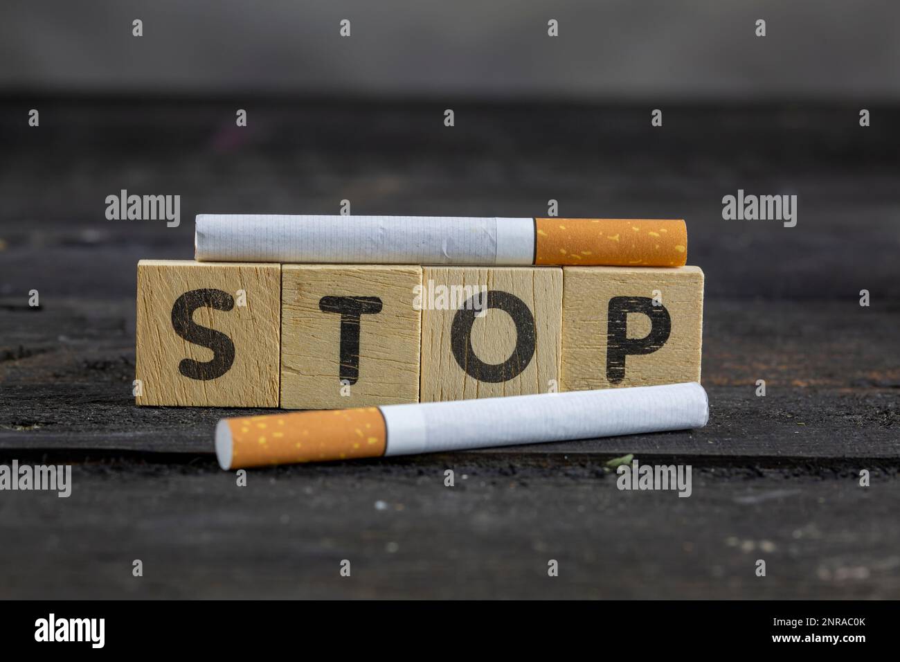 Cigarettes And Wooden Blocks Showing Stop Word On Desk Stock Photo