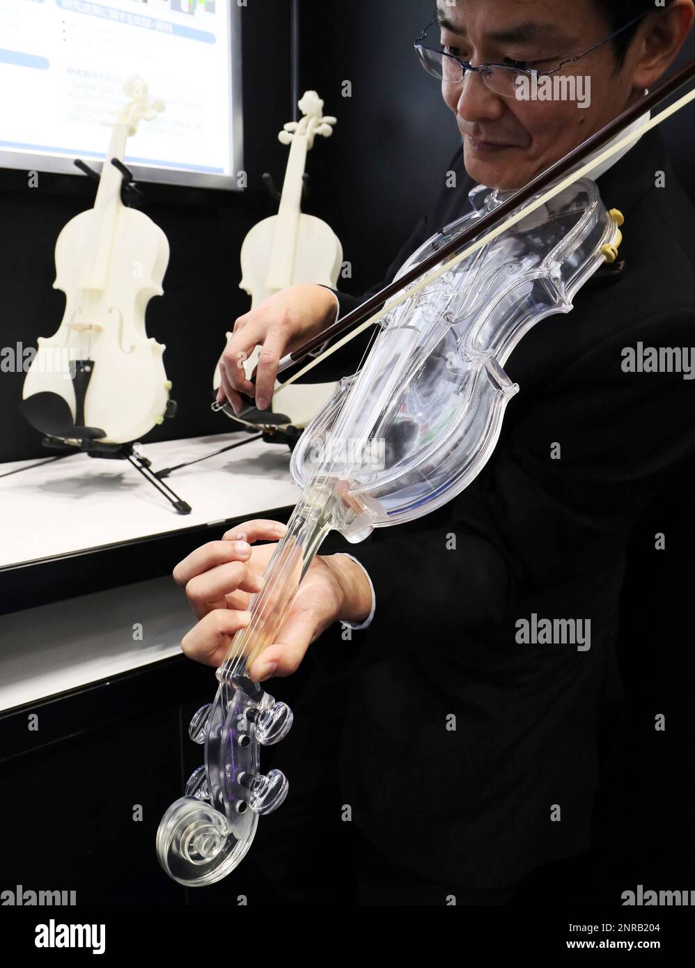 Okklusion skepsis St A photo shows a transparent plastic violin made by 3D printer (the back  violin is a non-transparent violin made two years ago) at Tokyo Big Sight  in Koto Ward, Tokyo on January