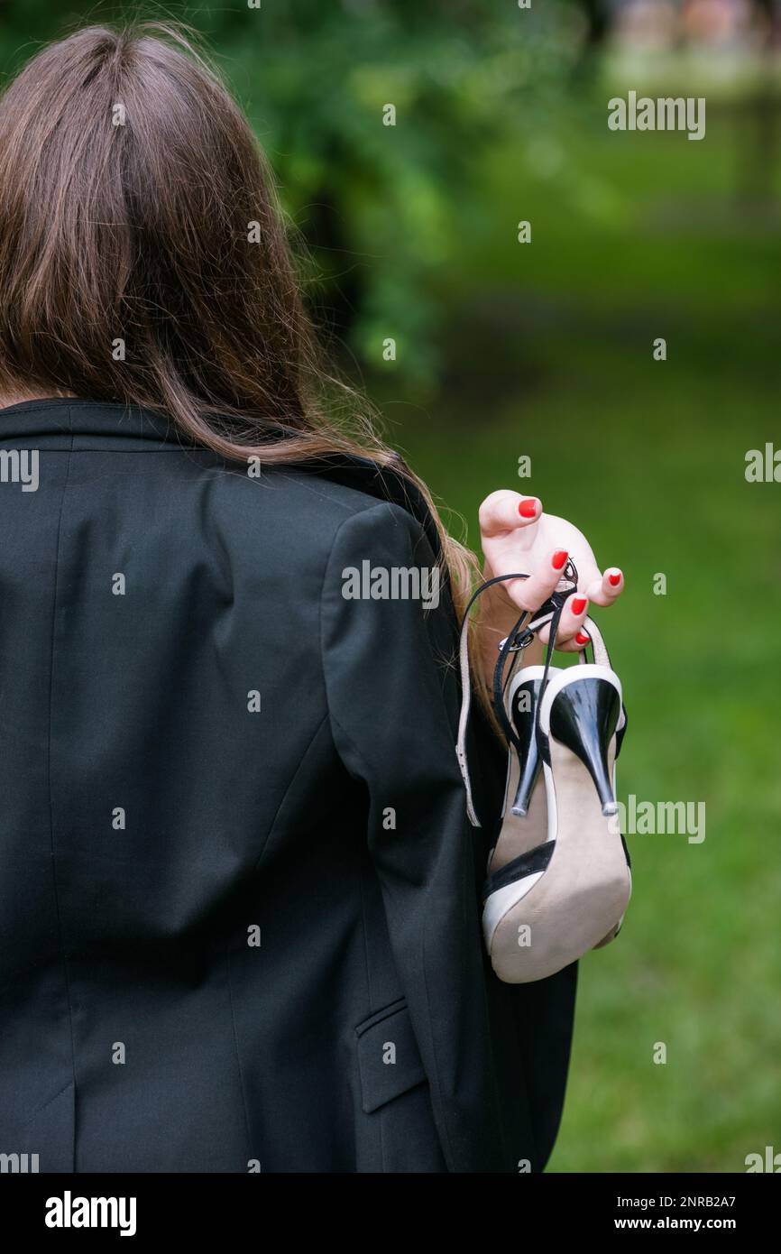 Selfconfident woman walking without her shoes Stock Photo Alamy