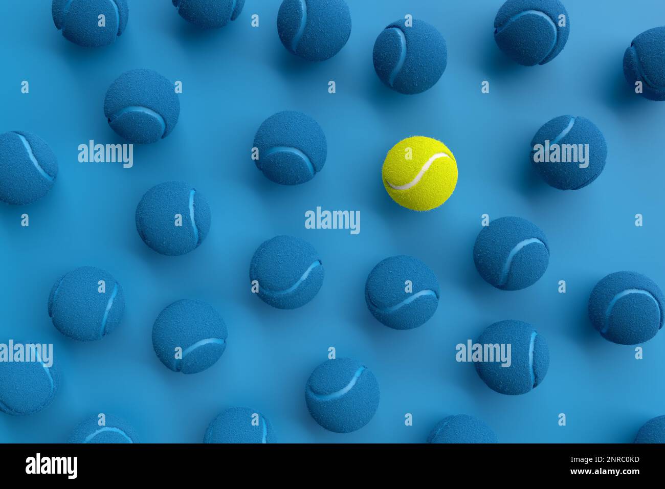 Individuality, difference, diversity, uniqueness and leadership concepts. Standing out from the crowd. Yellow tennis ball surrounded with blue tennis Stock Photo