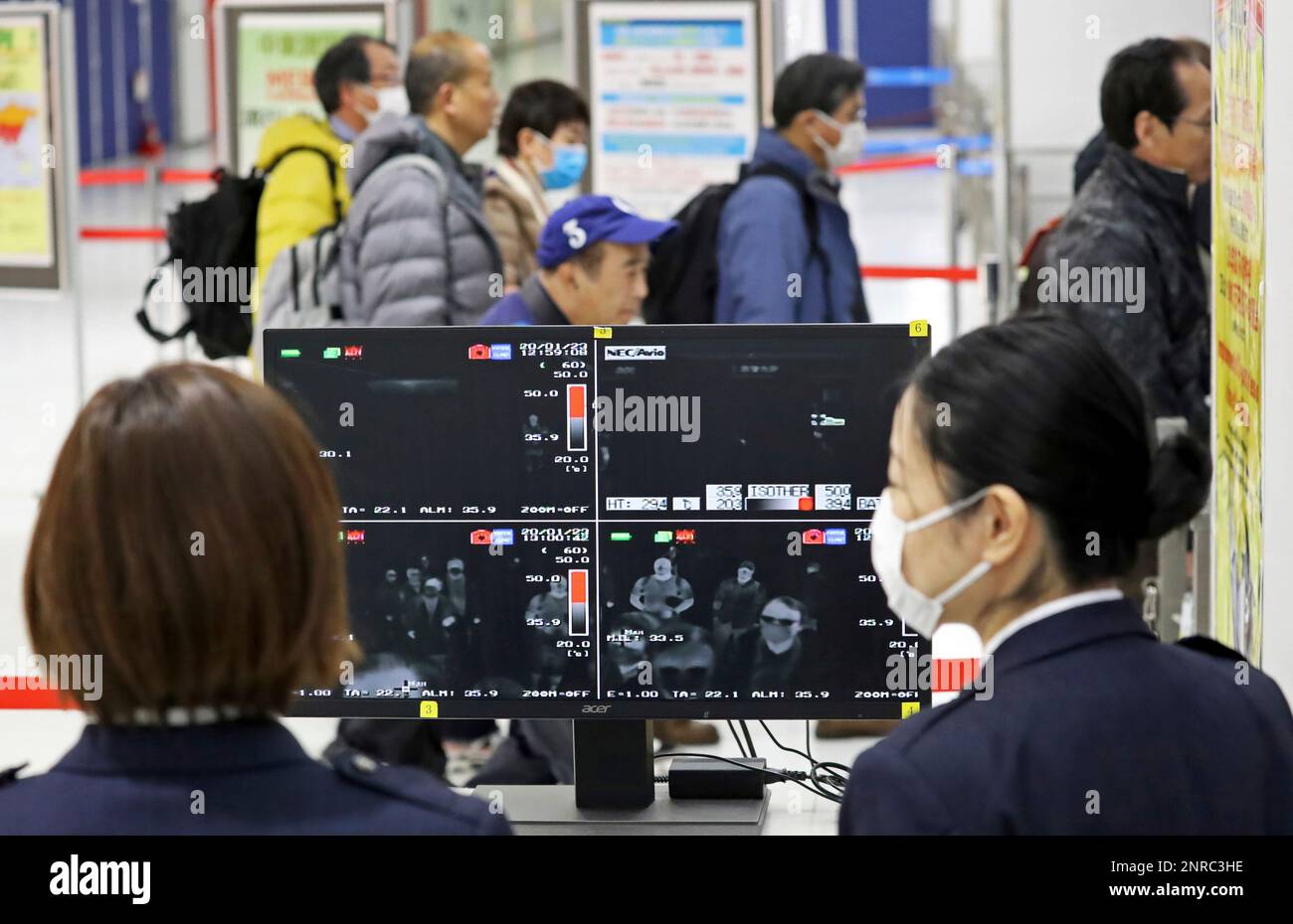 Passengers wearing mask pass near thermography at quarantine inspection