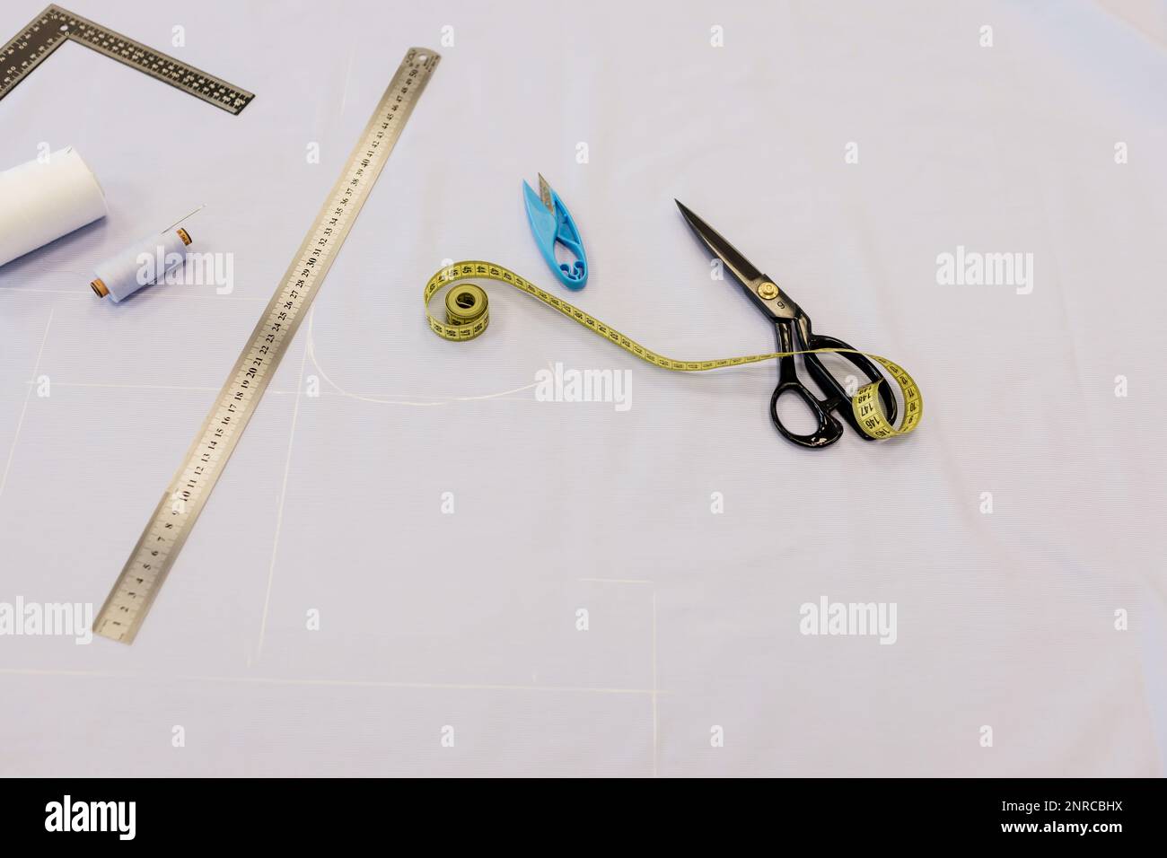 Scissors and measuring tape on pattern of sewing Stock Photo by  ©ChamilleWhite 19673309