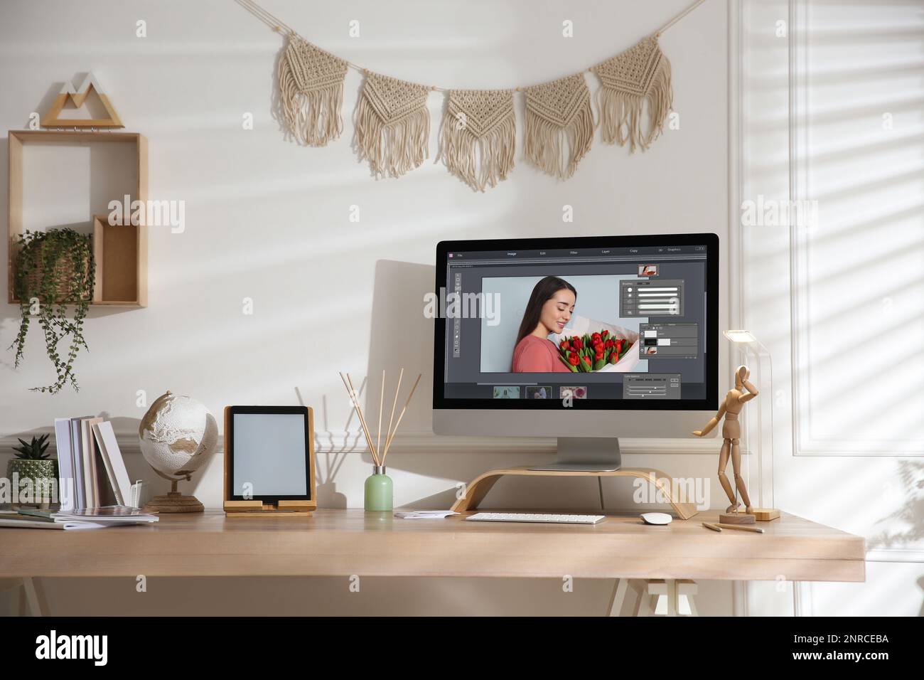 Designer's workplace. Computer with photo editor application on table indoors Stock Photo