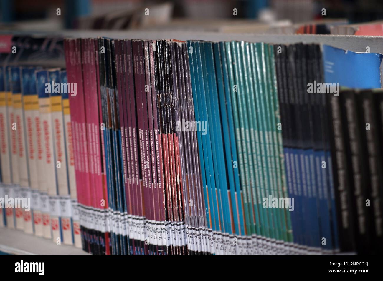 School Textbooks Neatly Arranged On An Iron Shelf, In The Air Belo Village School Library During The Day Stock Photo