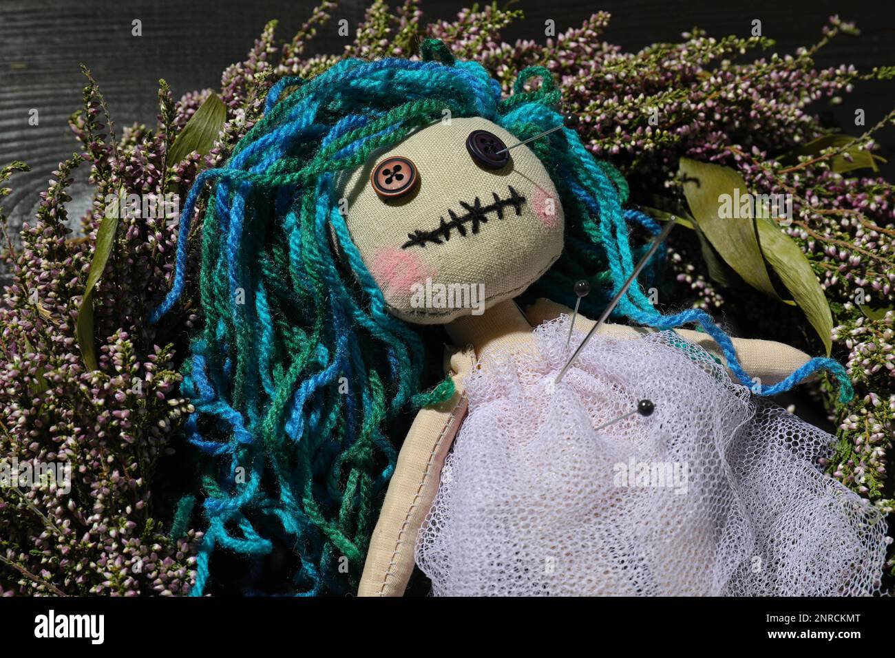 Female voodoo doll with pins on wreath, closeup Stock Photo - Alamy