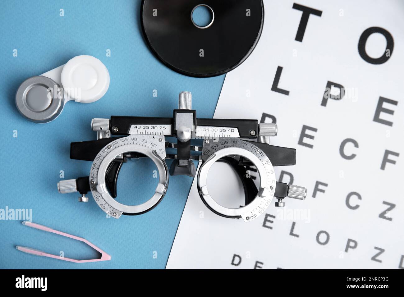 Different ophthalmologist tools on light blue background, flat lay Stock Photo Alamy
