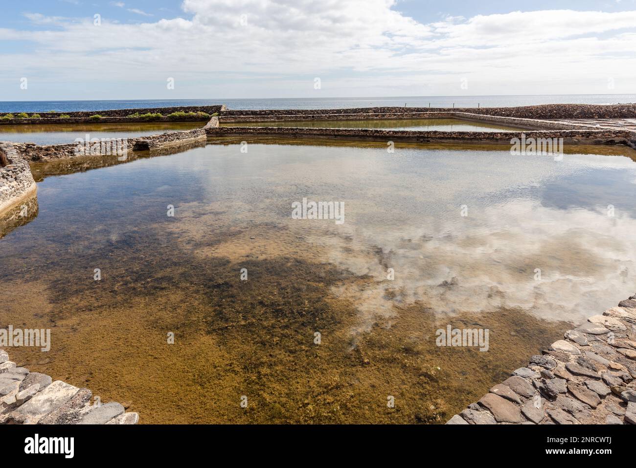 Concentration basin upstream of the saltworks evaporation pans of the salt museum in Fuerteventura. Stock Photo