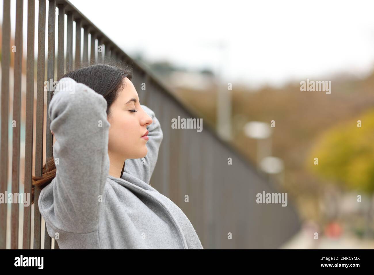 Profile of a woman resting and relaxing in the street Stock Photo