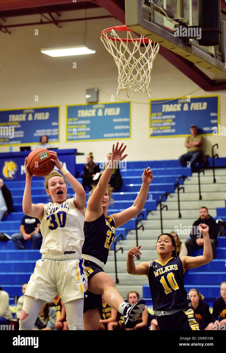 Misericordia's Jordan Barth (30) grabs the rebound from Wilkes' Ariel