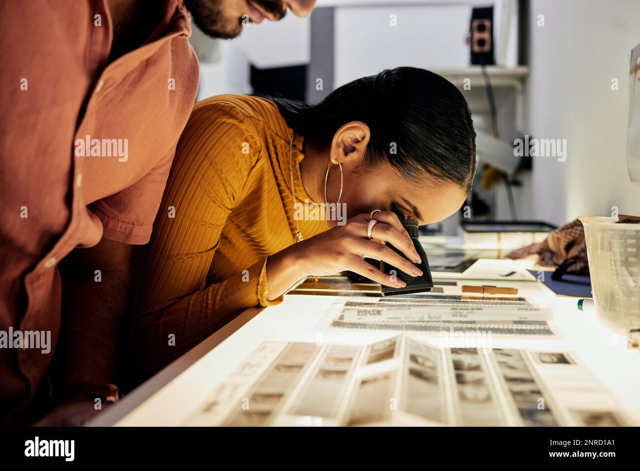 Photography, editing and film negatives for looking, magnifying glass