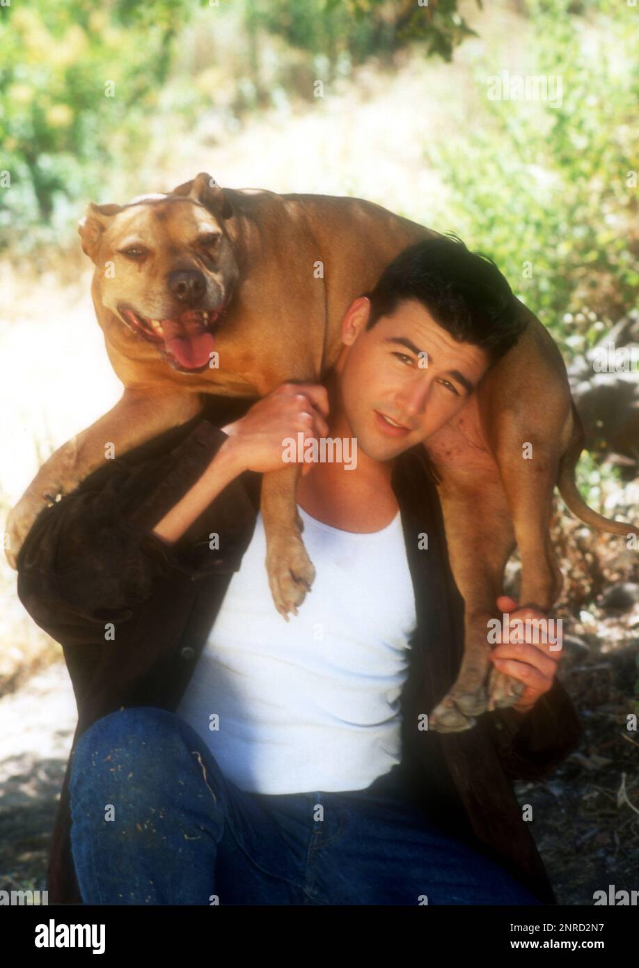 Los Angeles, California, USA 1st July 1996 (EXCLUSIVE) Actor Kyle Candler poses with his dog at an exclusive photo shoot on July 1, 1996 in Los Angeles, California, USA. Photo by Barry King/Alamy Stock Photo Stock Photo