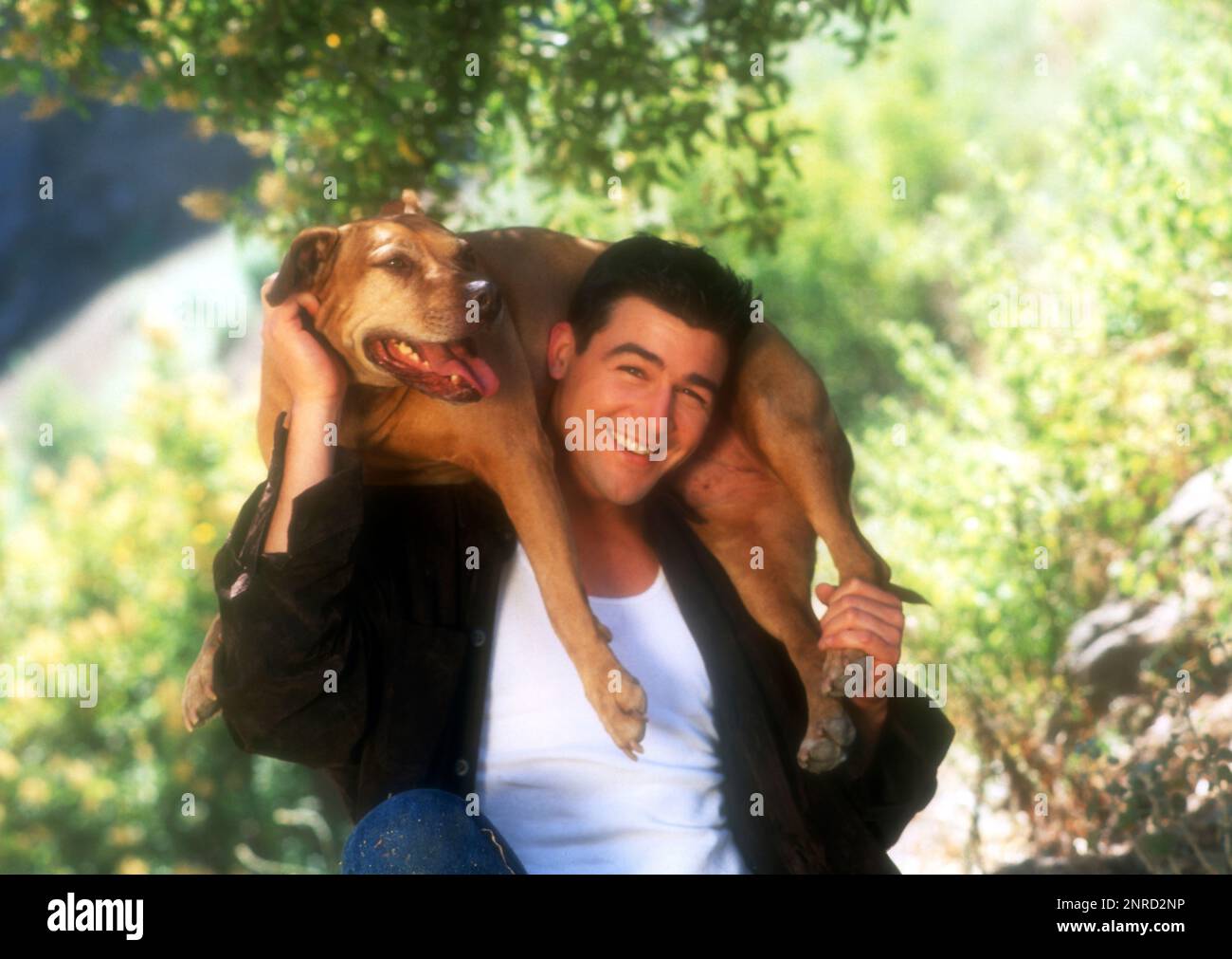 Los Angeles, California, USA 1st July 1996 (EXCLUSIVE) Actor Kyle Candler poses with his dog at an exclusive photo shoot on July 1, 1996 in Los Angeles, California, USA. Photo by Barry King/Alamy Stock Photo Stock Photo