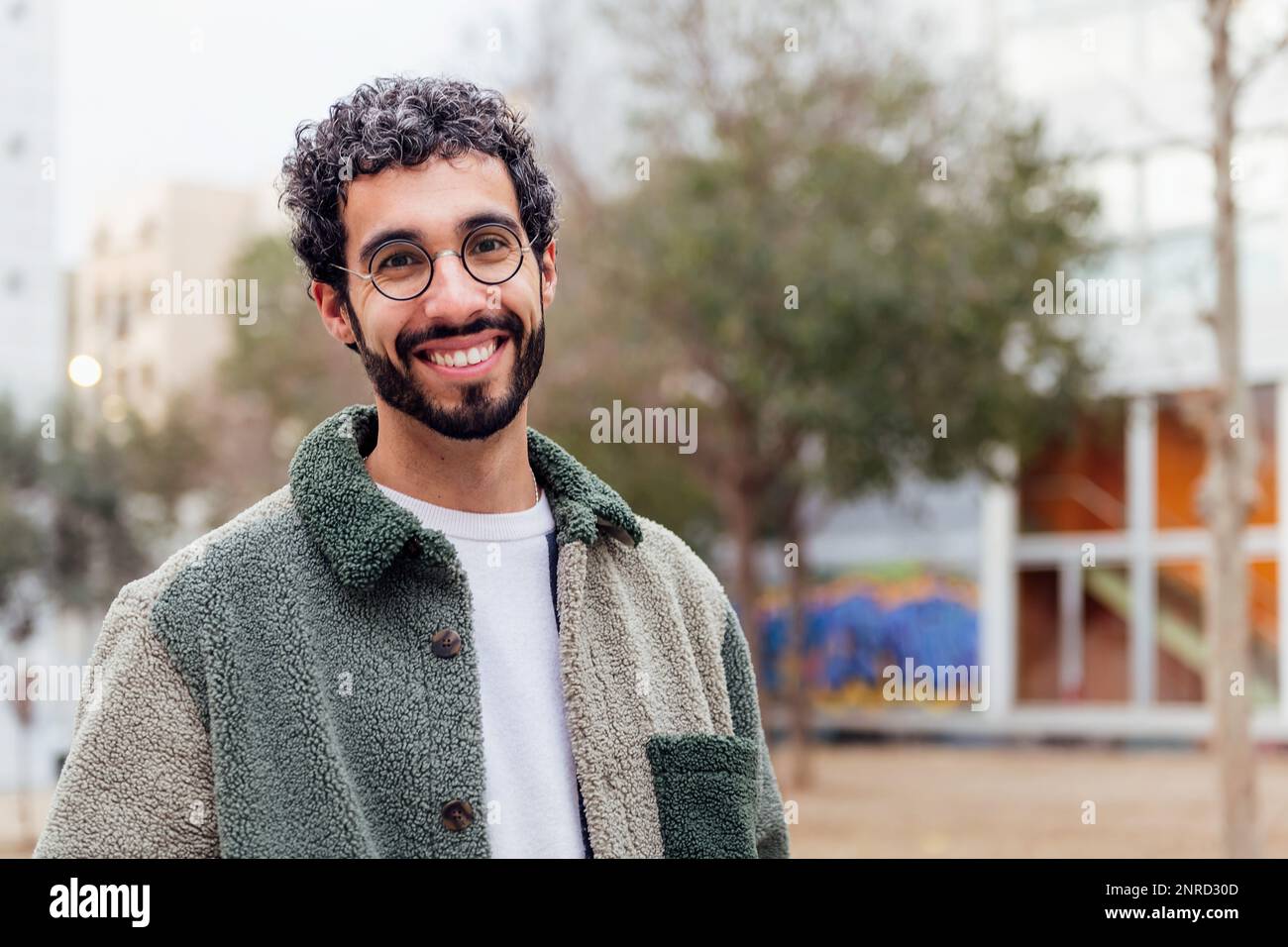 young man with beard smiling looking at camera Stock Photo