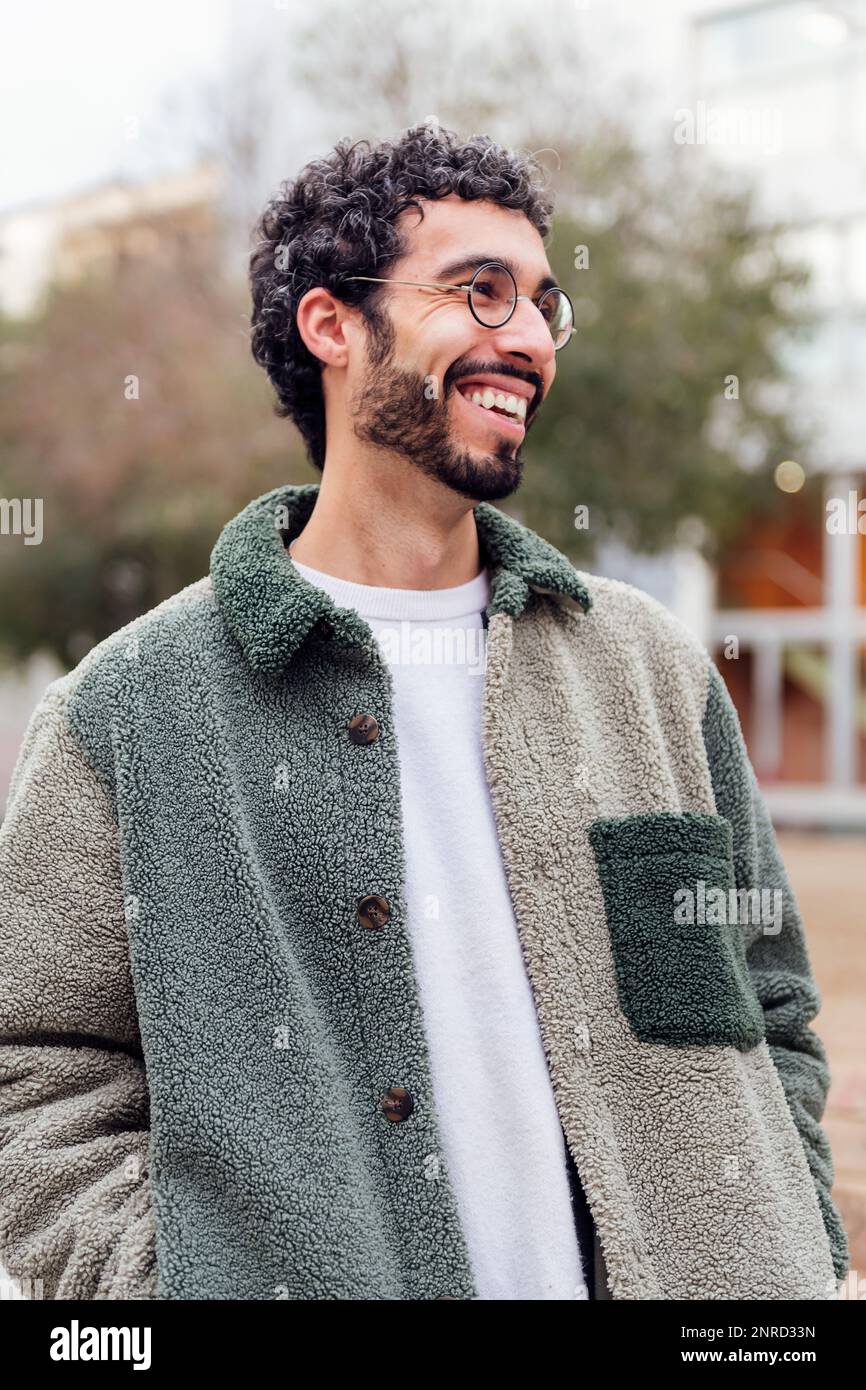young man with beard and glasses laughing happy Stock Photo