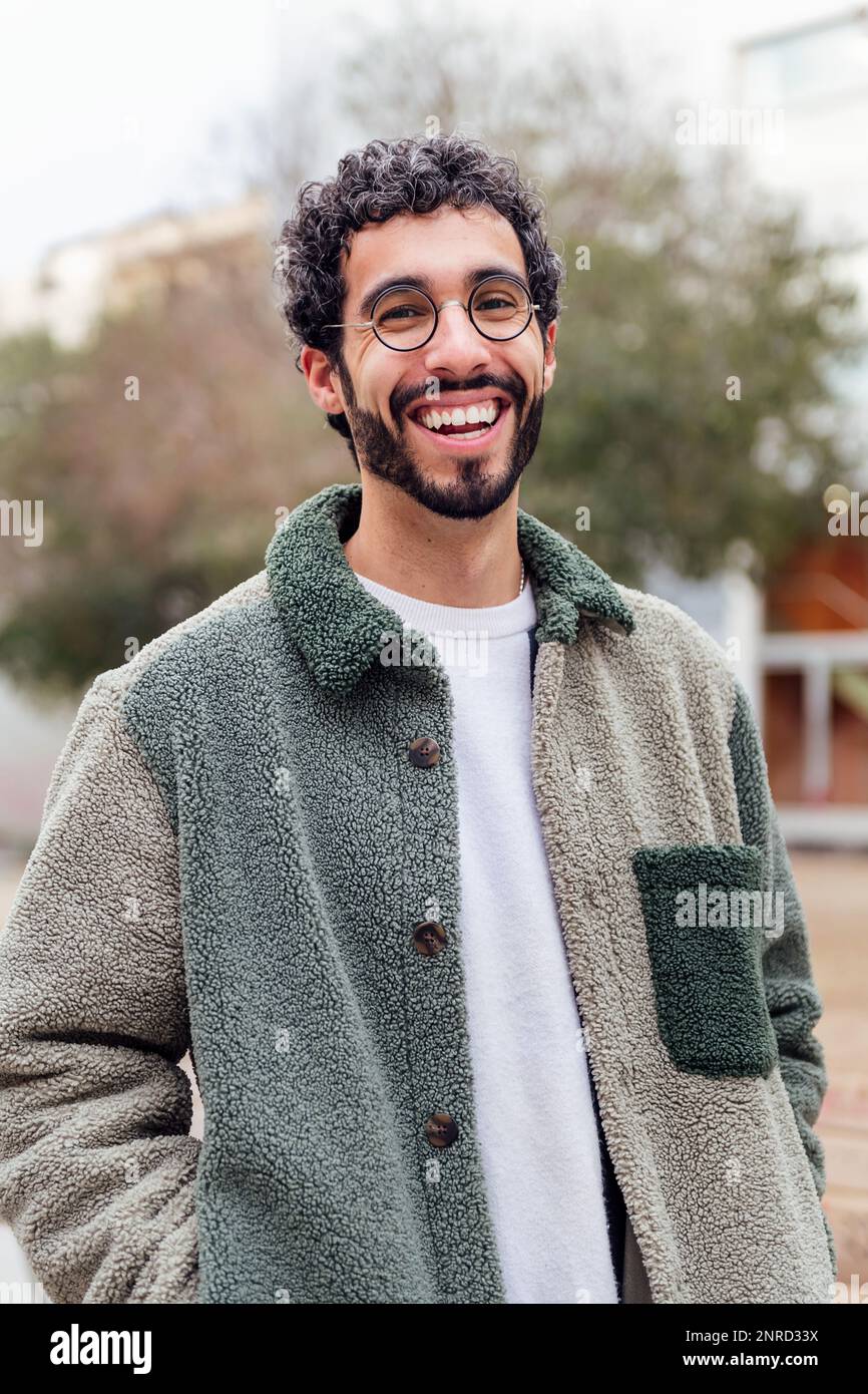 young man with beard laughing looking at camera Stock Photo