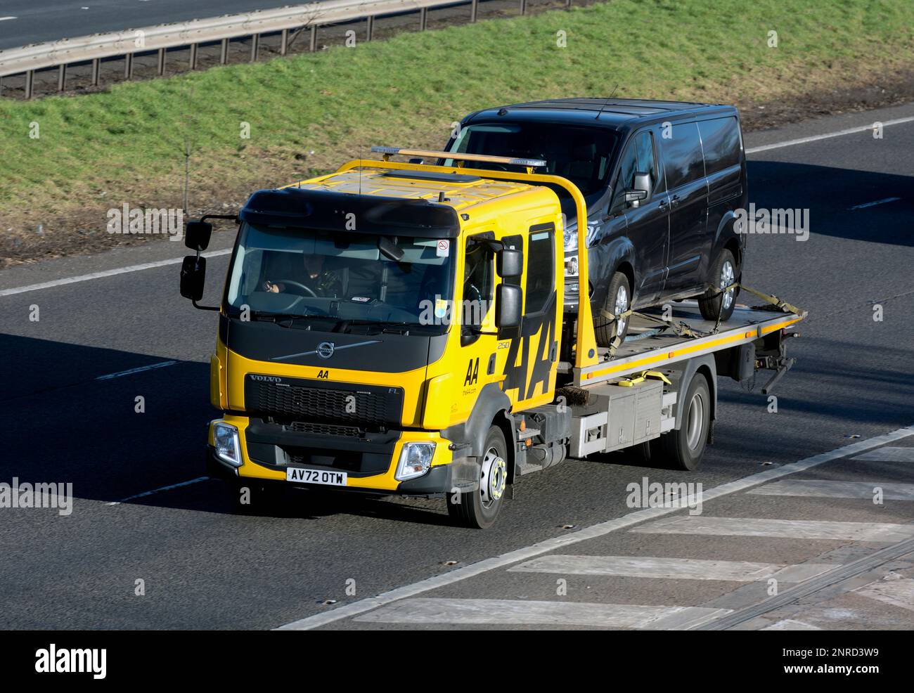 AA recovery lorry carrying a van on the M40 motorway, Warwickshire, UK Stock Photo