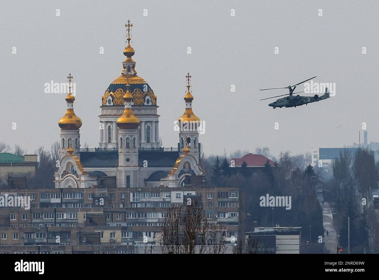 A Russian Ka-52 'Alligator' attack helicopter flies near a church in the course of Russia-Ukraine conflict in Donetsk, Russian-controlled Ukraine, February 27, 2023. REUTERS/Alexander Ermochenko Stock Photo