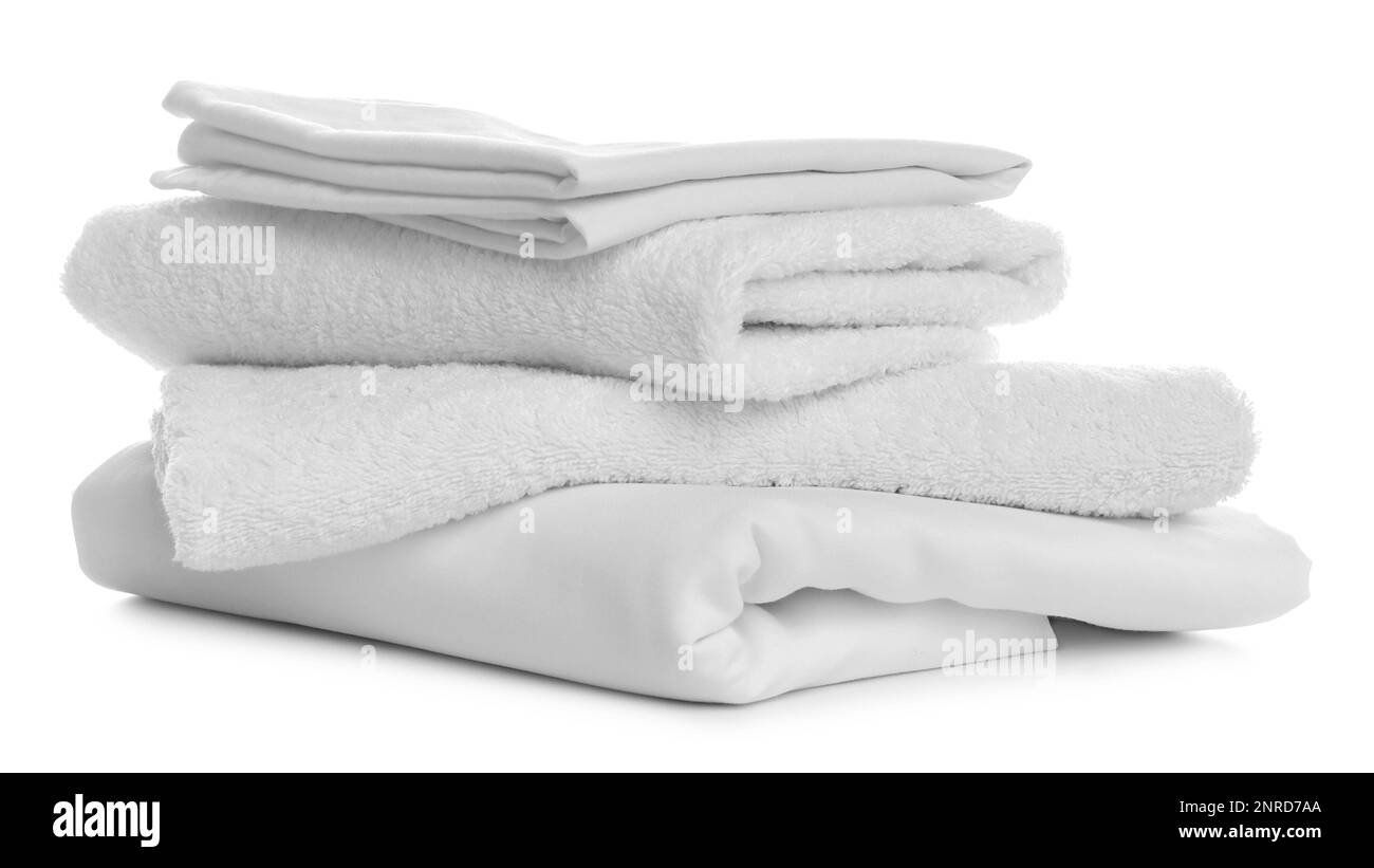 Stack of towels and bedding on white background Stock Photo Alamy
