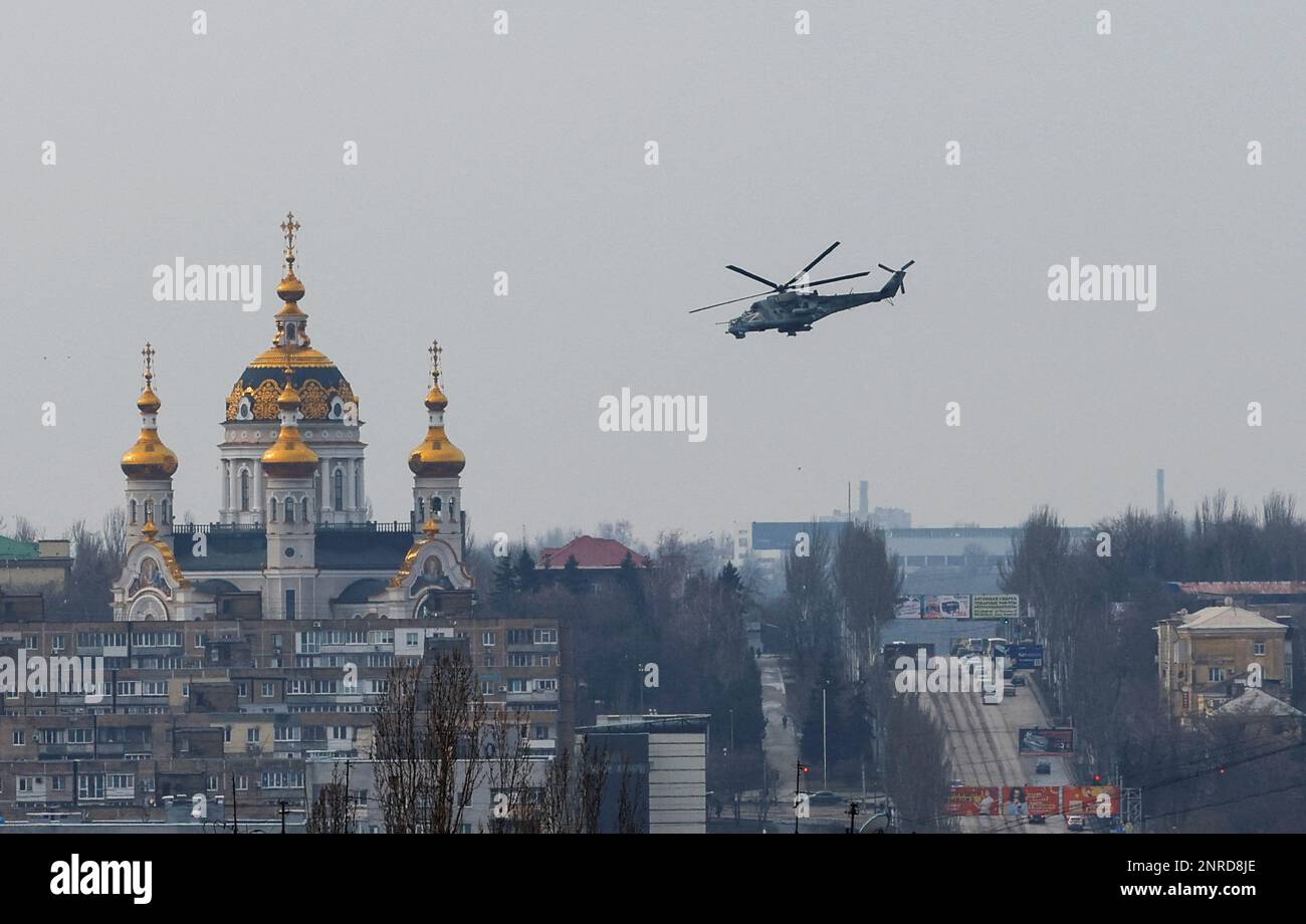 A Russian military helicopter flies near a church in the course of Russia-Ukraine conflict in Donetsk, Russian-controlled Ukraine, February 27, 2023. REUTERS/Alexander Ermochenko Stock Photo