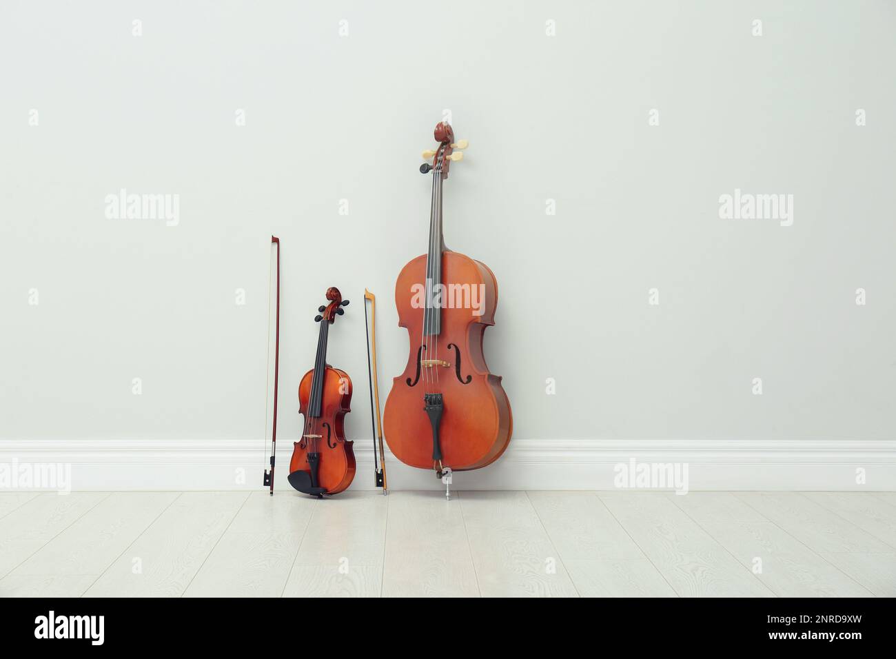 Stringed musical instruments near white wall indoors Stock Photo Alamy